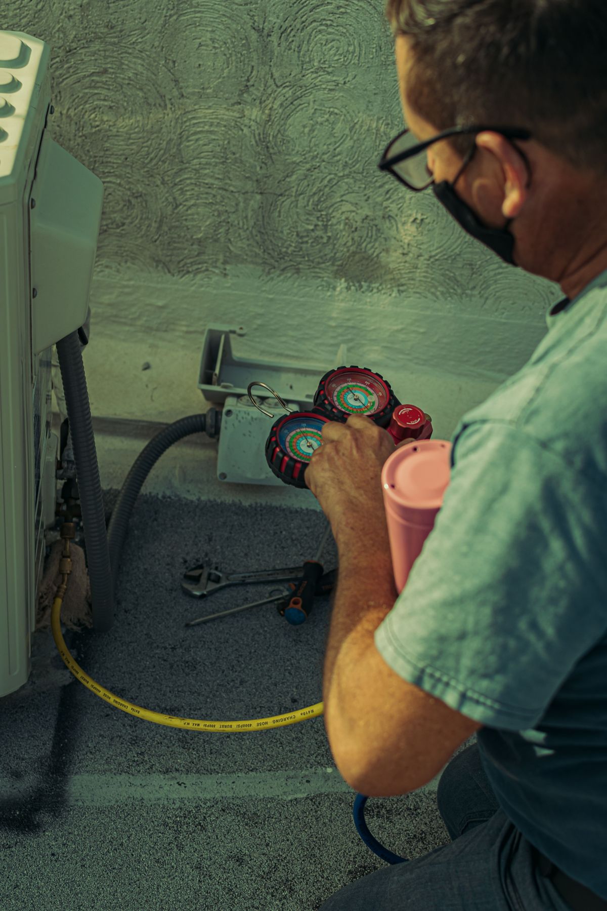 Technician performing air conditioning maintenance in Perth