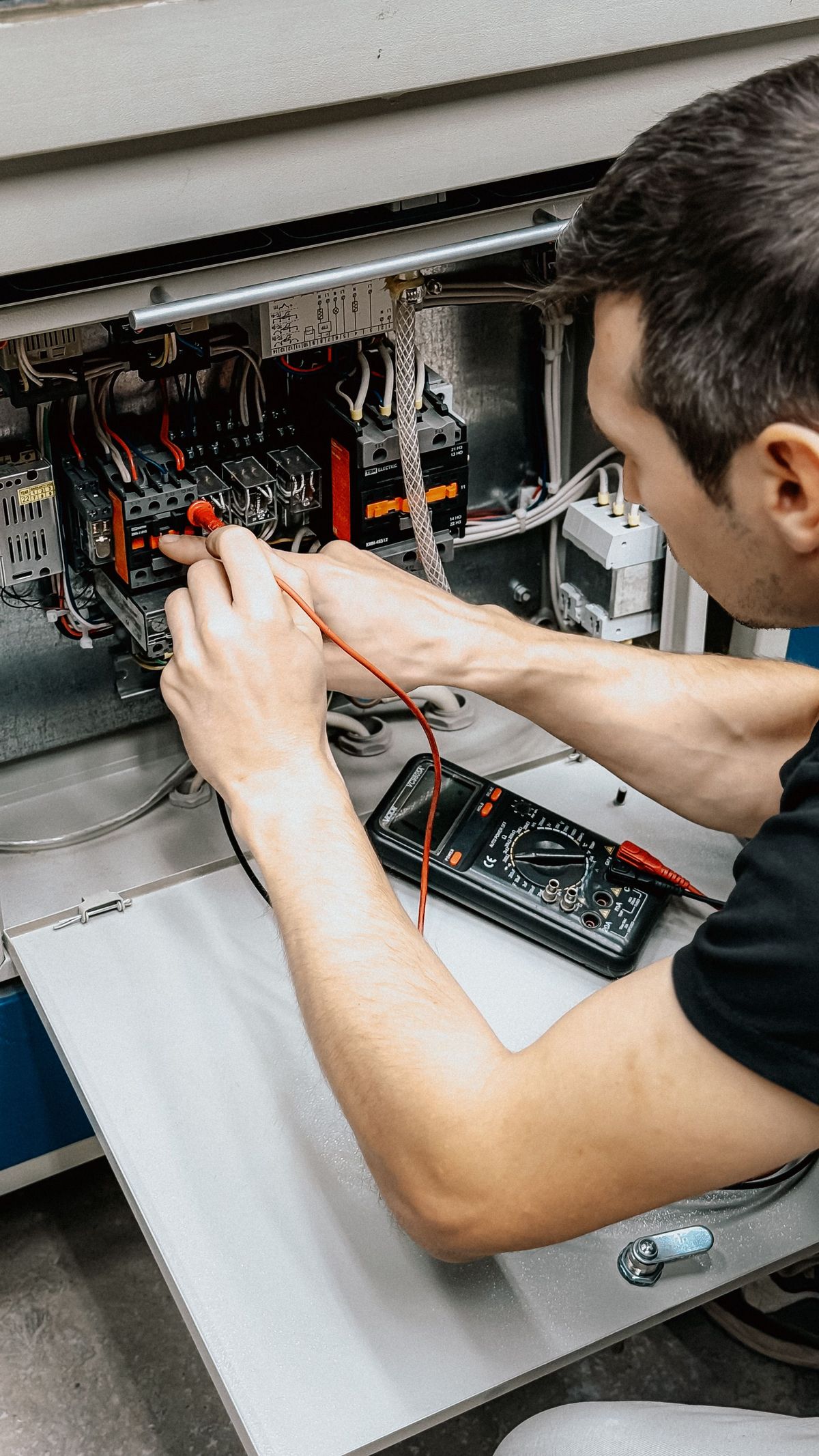 Certified electrician testing air conditioning electrical panel, Perth northern suburbs