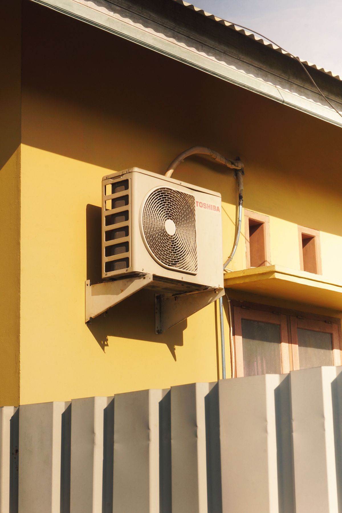 Outdoor split system condenser unit installed on home wall Wanneroo